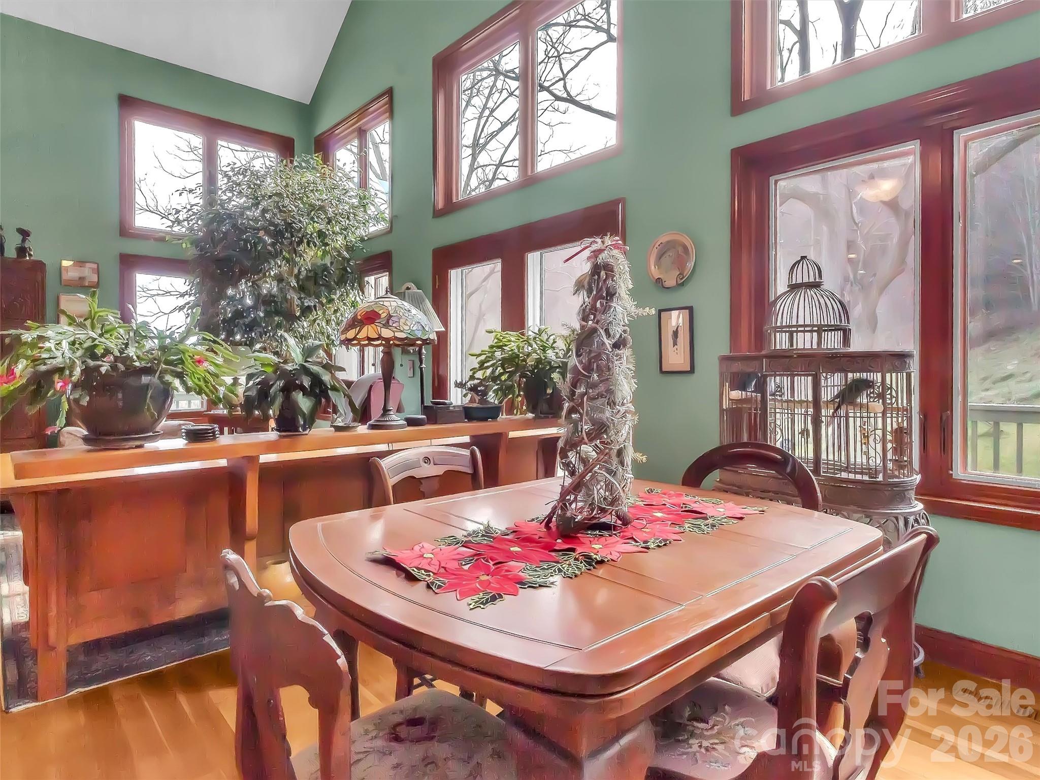 1201 Cathey Cove Road Waynesville, NC 28786 - Photo 15 of 48 a dining room with furniture a large window and a chandelier