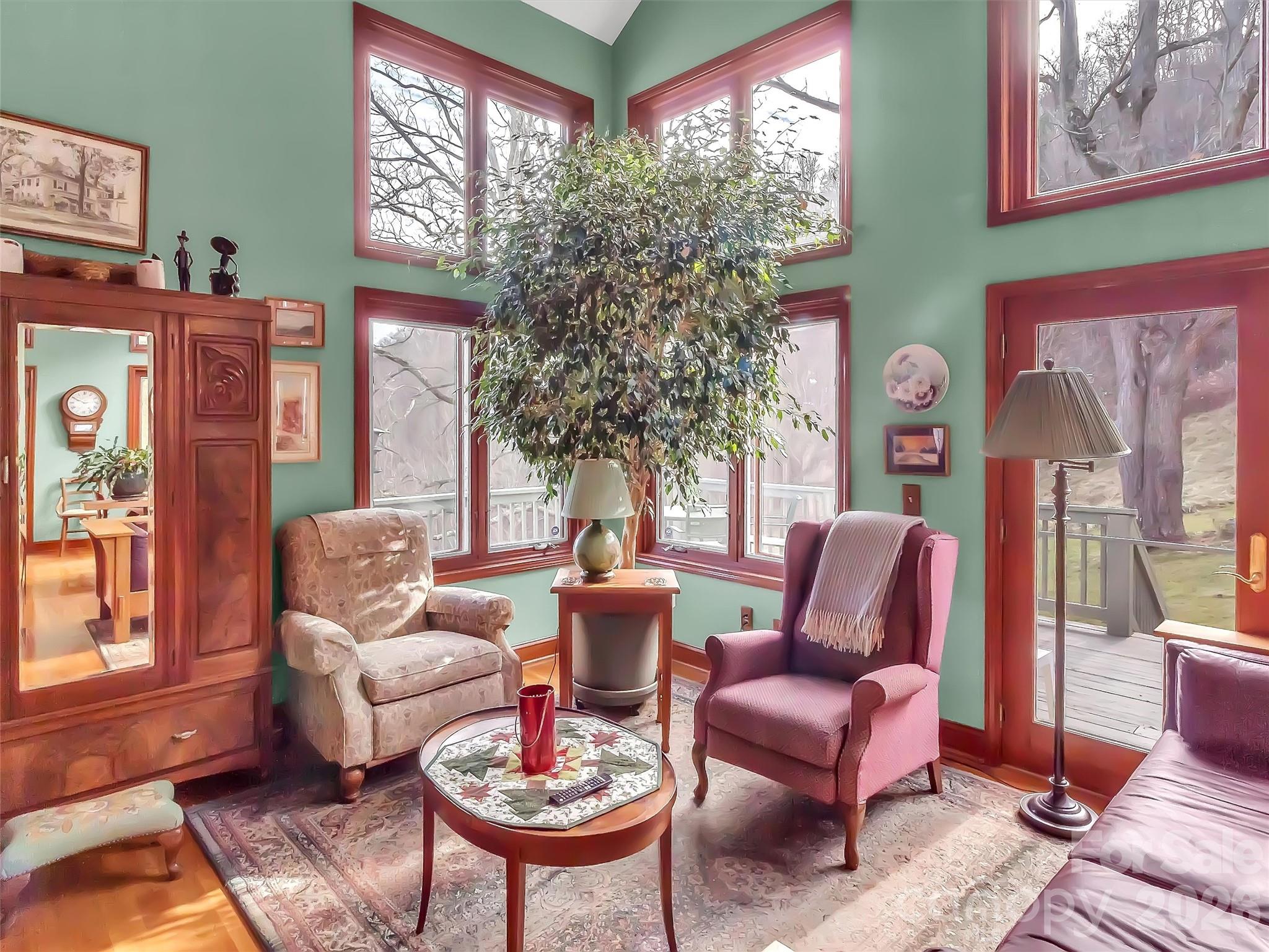 1201 Cathey Cove Road Waynesville, NC 28786 - Photo 16 of 48 a living room with patio furniture and a potted plant