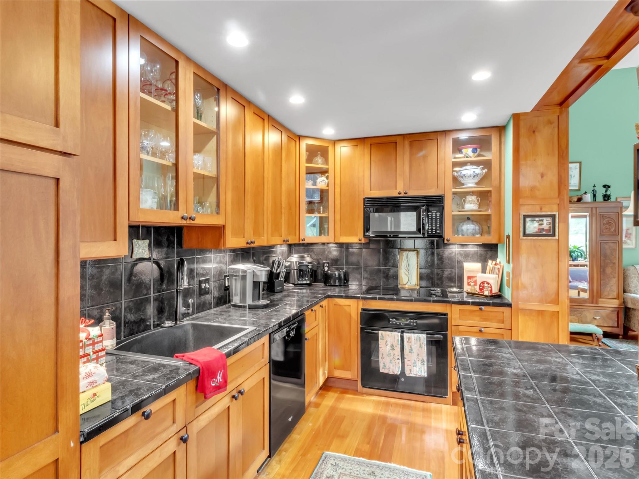 1201 Cathey Cove Road Waynesville, NC 28786 - Photo 20 of 48 a kitchen with stainless steel appliances granite countertop a stove a sink and a microwave