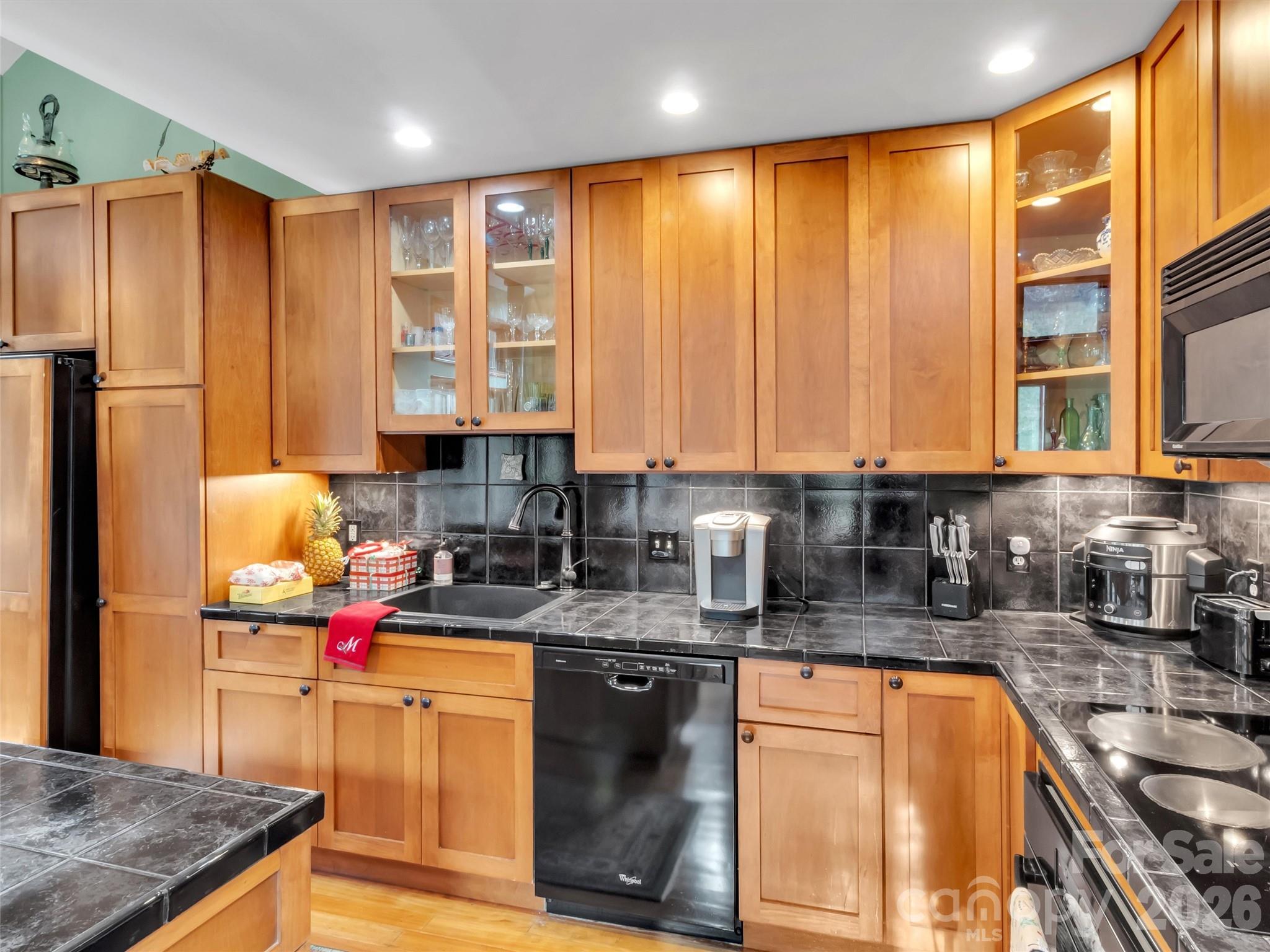 1201 Cathey Cove Road Waynesville, NC 28786 - Photo 21 of 48 a kitchen with stainless steel appliances granite countertop a sink stove and refrigerator