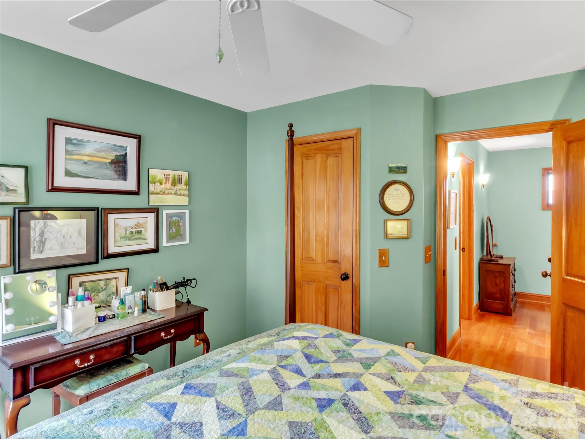 1201 Cathey Cove Road Waynesville, NC 28786 - Photo 23 of 48 a bedroom with a bed and wooden floor