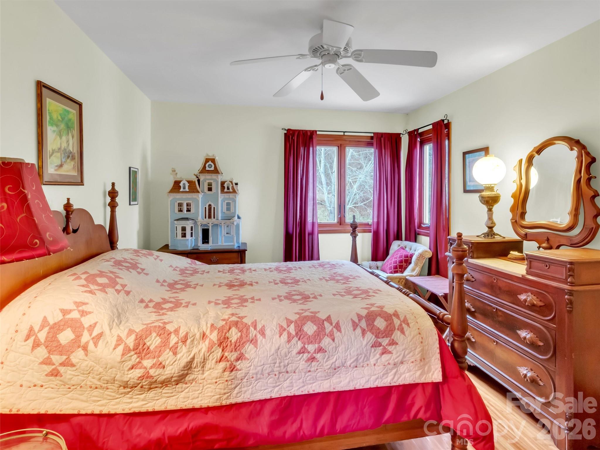 1201 Cathey Cove Road Waynesville, NC 28786 - Photo 32 of 48 a bedroom with a bed a dresser and window