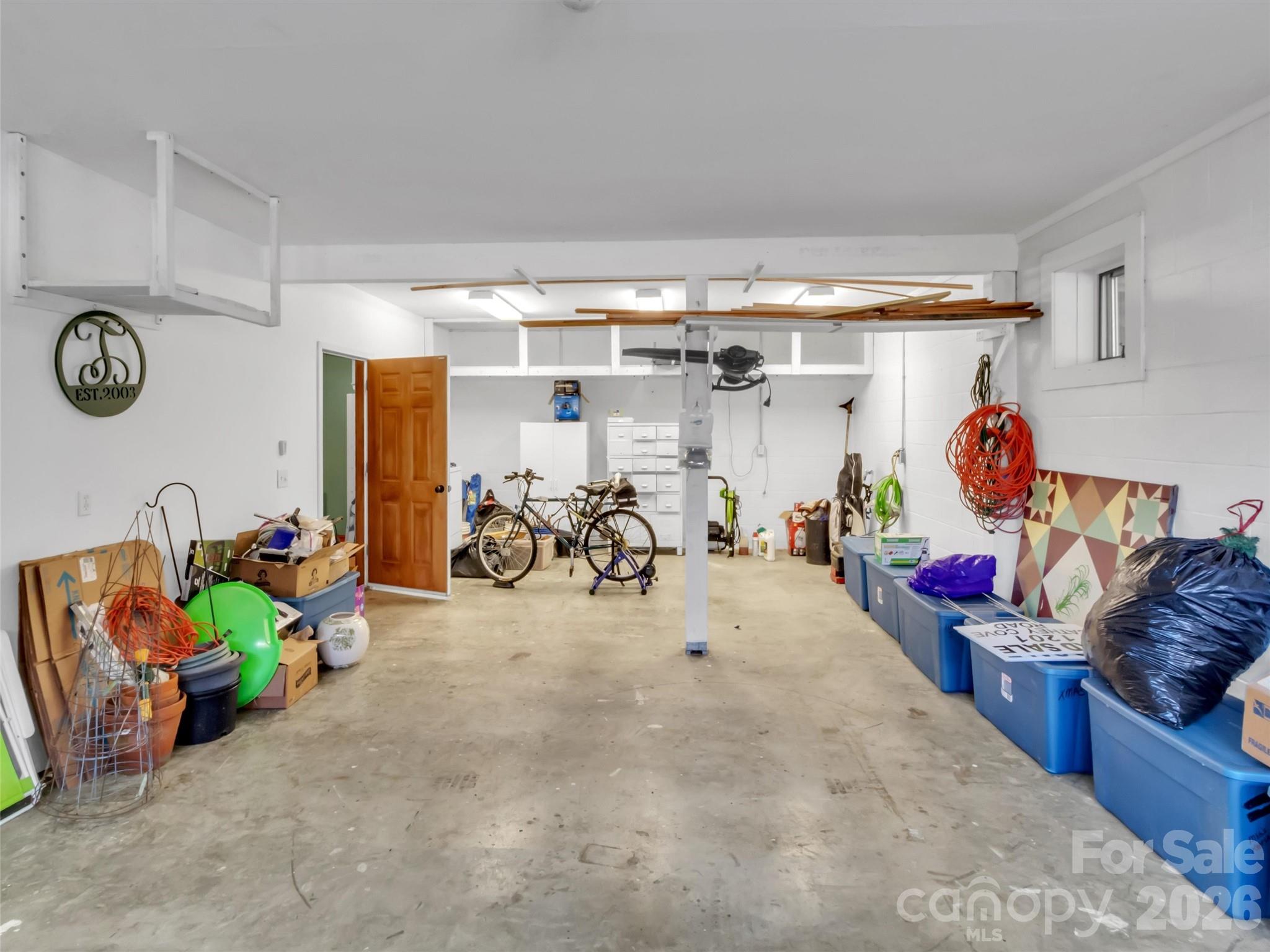 1201 Cathey Cove Road Waynesville, NC 28786 - Photo 42 of 48 a storage room with lots of white furniture a rug and a window
