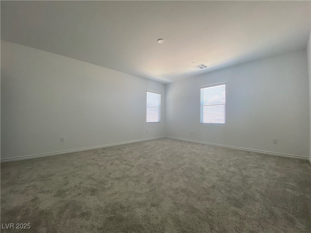 8846 Sasquatch Run Avenue Las Vegas, NV 89166 - Photo 13 of 21 Carpeted empty room featuring baseboards