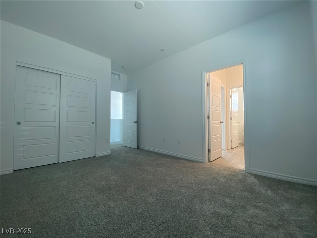 8846 Sasquatch Run Avenue Las Vegas, NV 89166 - Photo 14 of 21 Unfurnished bedroom with carpet and a closet