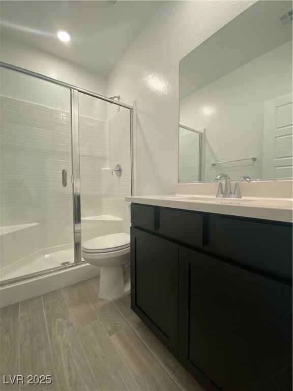 8846 Sasquatch Run Avenue Las Vegas, NV 89166 - Photo 18 of 21 Bathroom with light wood-style floors, a shower stall, and vanity