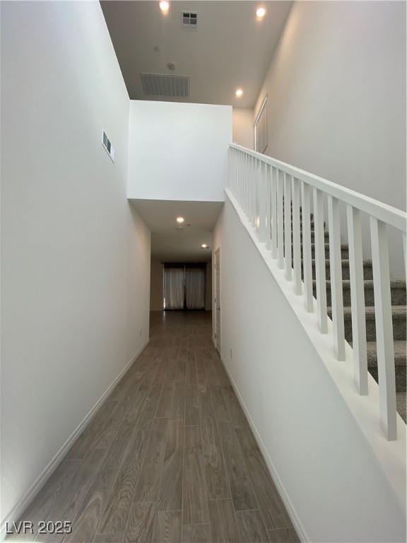 8846 Sasquatch Run Avenue Las Vegas, NV 89166 - Photo 9 of 21 Corridor with recessed lighting, wood finished floors, stairs, and a towering ceiling