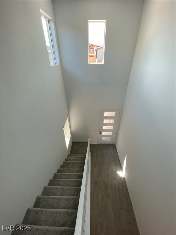 8846 Sasquatch Run Avenue Las Vegas, NV 89166 - Photo 10 of 21 Stairway featuring wood finished floors and a towering ceiling