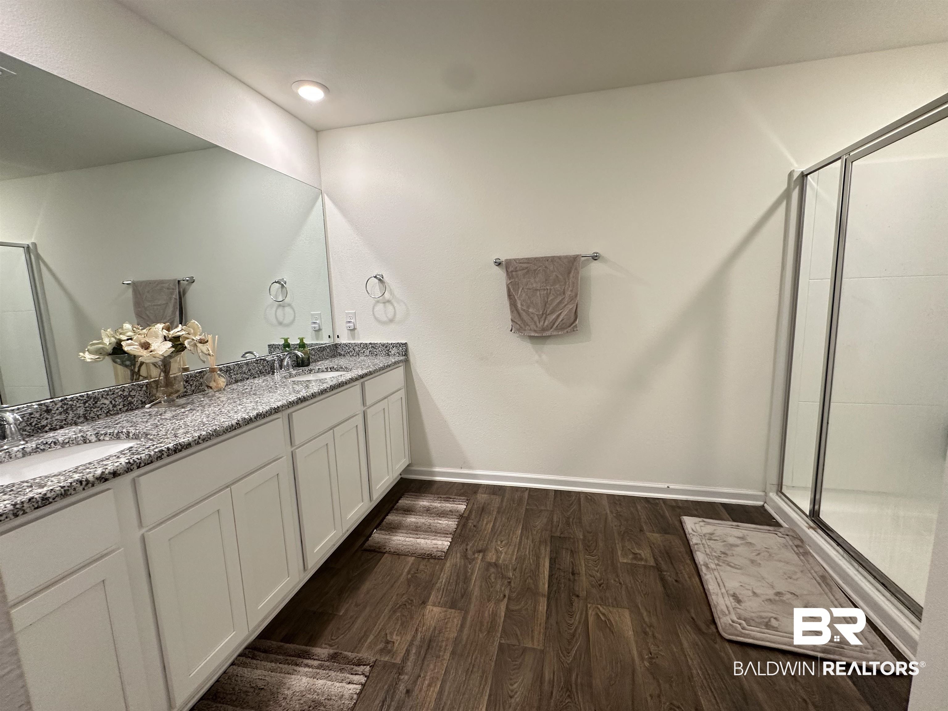23792 Unbridled Loop Daphne, AL 36526 - Photo 20 of 36 Bathroom featuring a shower stall, dark wood-style floors, and double vanity
