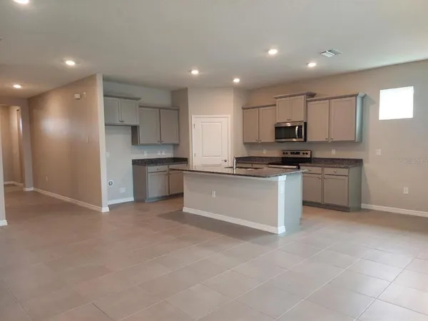 a large kitchen with cabinets and stainless steel appliances