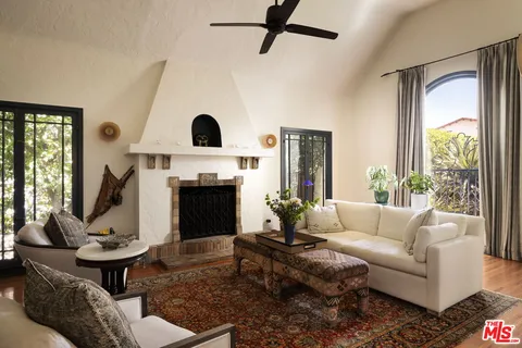 a living room with furniture fireplace and window