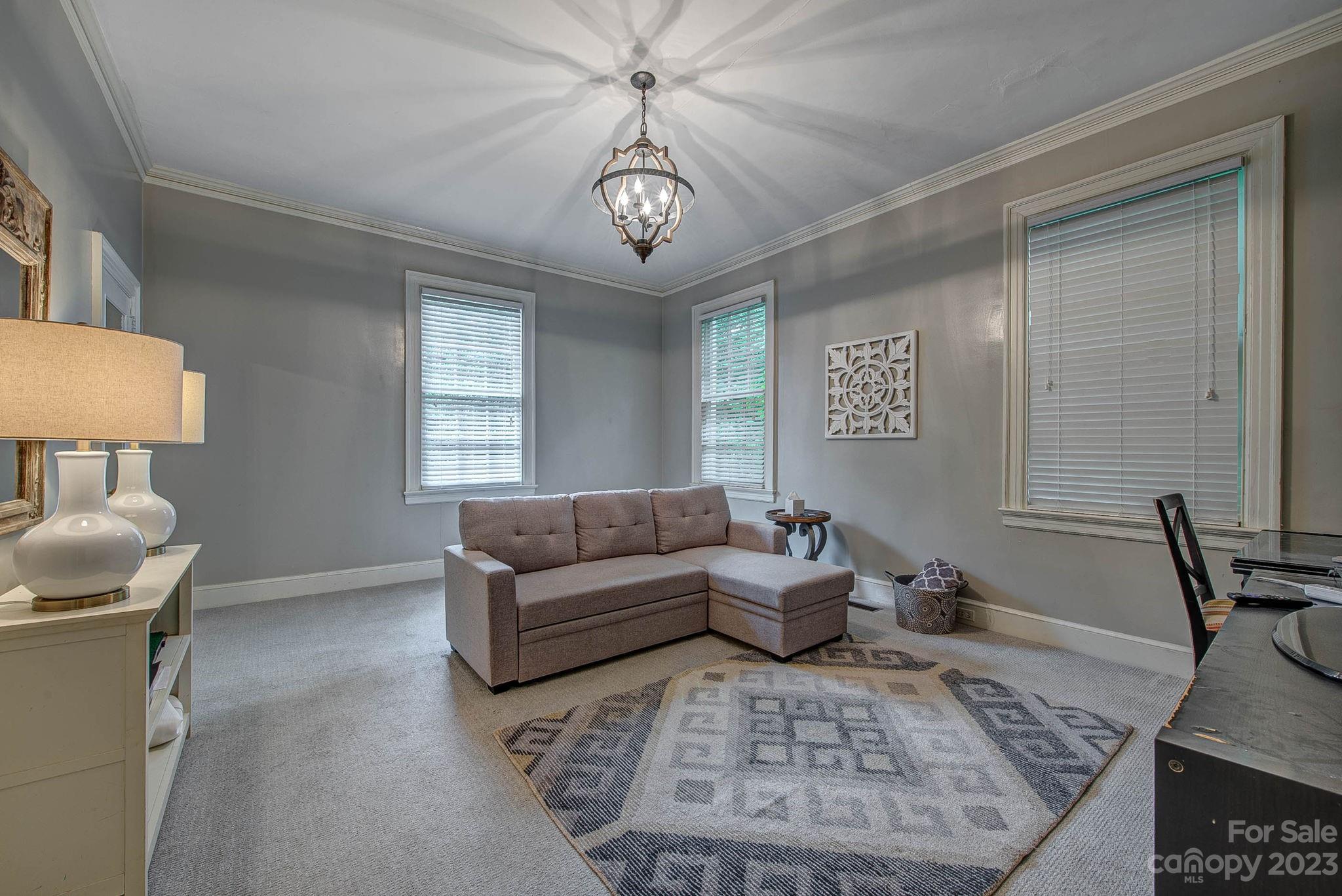 104 East Ridge Street Kings Mountain, NC 28086 - Photo 24 of 48 a living room with furniture and a chandelier