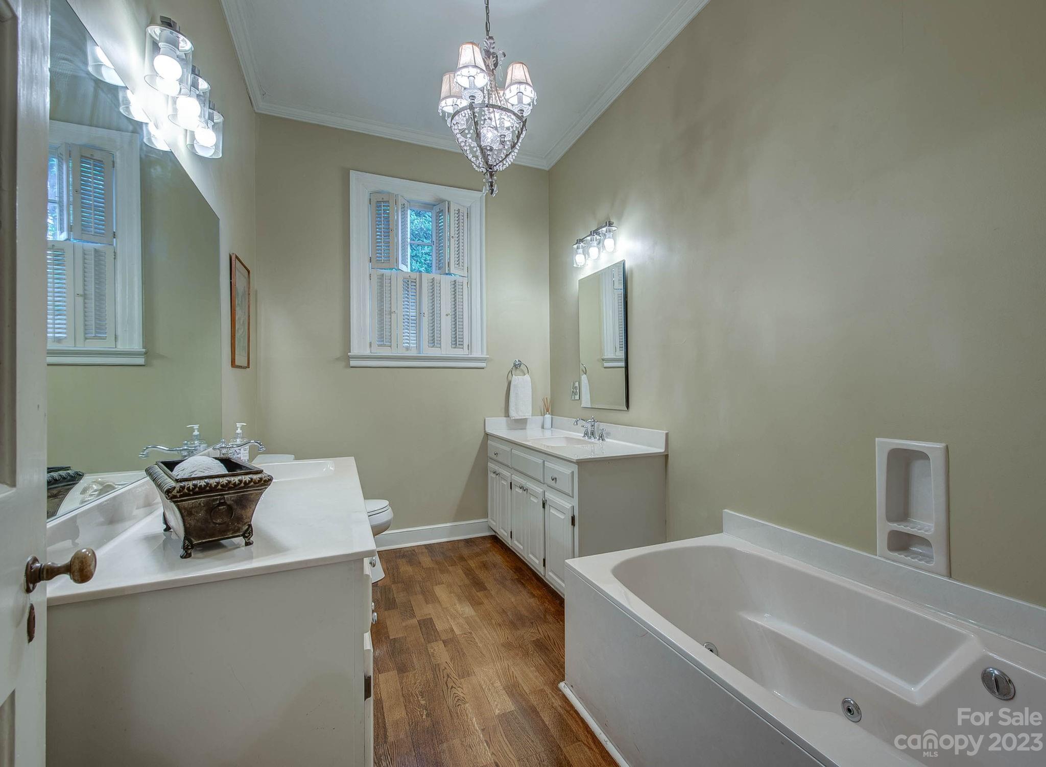 104 East Ridge Street Kings Mountain, NC 28086 - Photo 25 of 48 a bathroom with a tub sink and a mirror