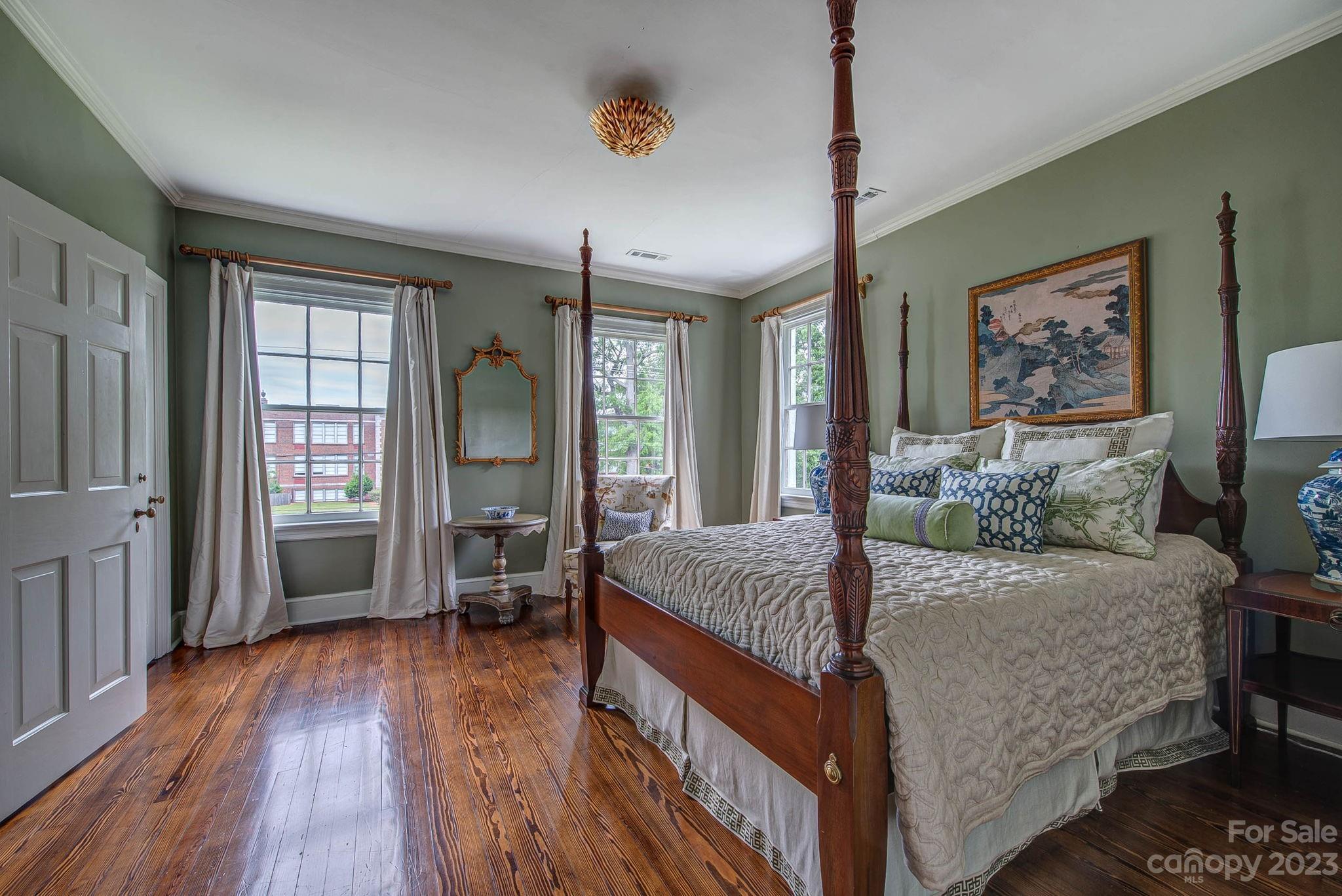 104 East Ridge Street Kings Mountain, NC 28086 - Photo 32 of 48 a bedroom with a large bed and a chandelier