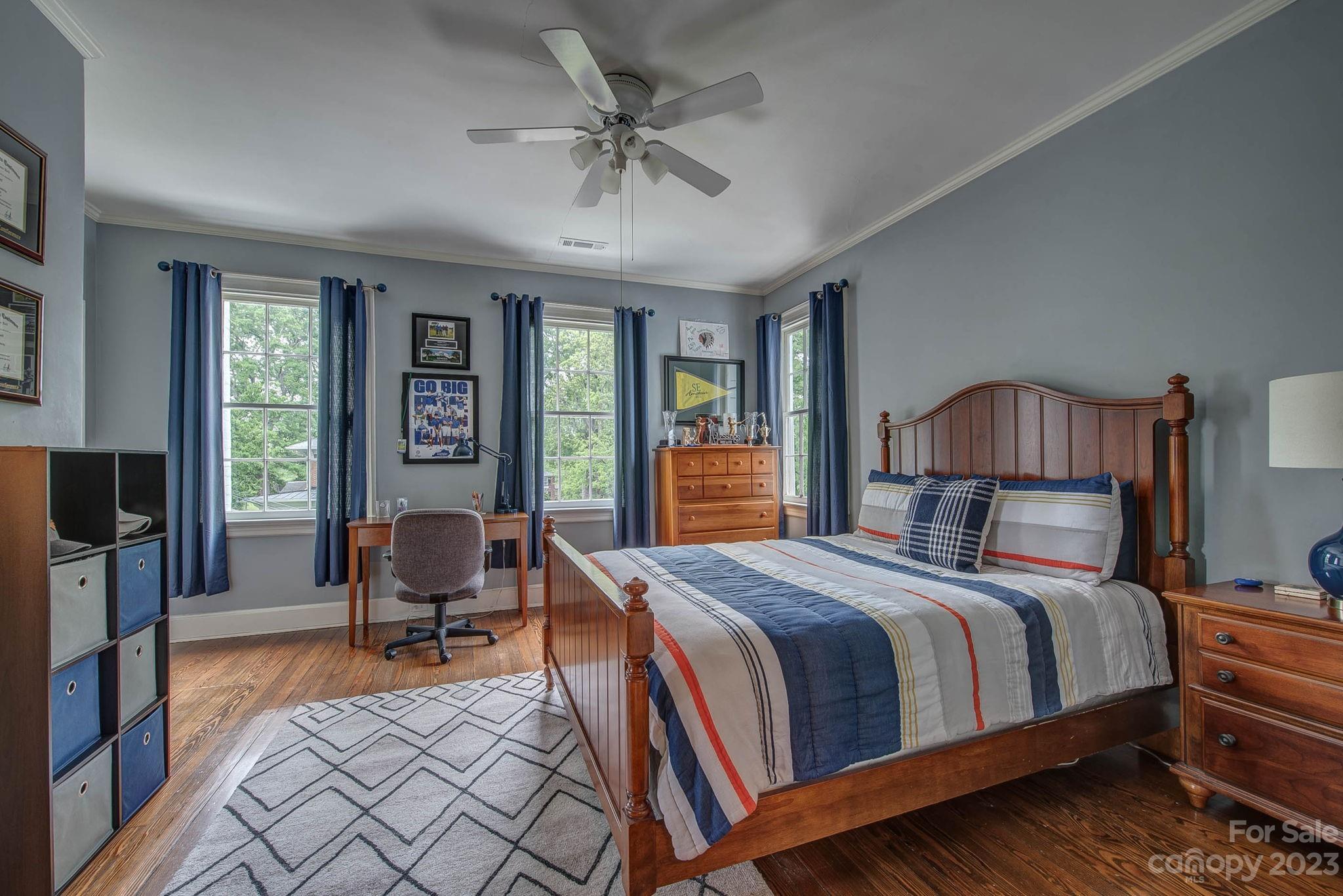 104 East Ridge Street Kings Mountain, NC 28086 - Photo 33 of 48 a bedroom with a bed and a chandelier