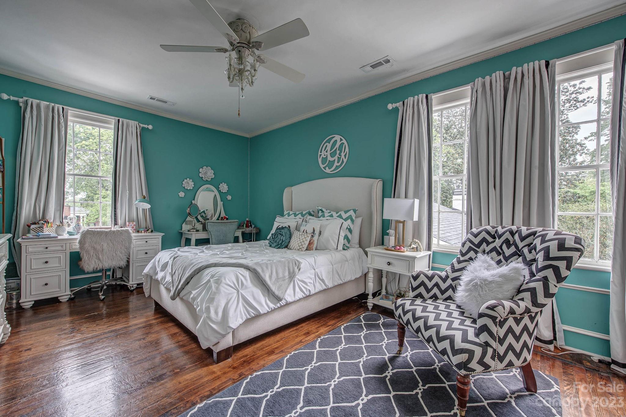 104 East Ridge Street Kings Mountain, NC 28086 - Photo 35 of 48 a bedroom with a bed and a chandelier