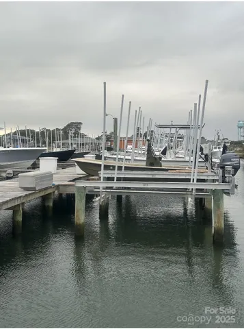 a roof deck with table and chairs a barbeque with wooden floor