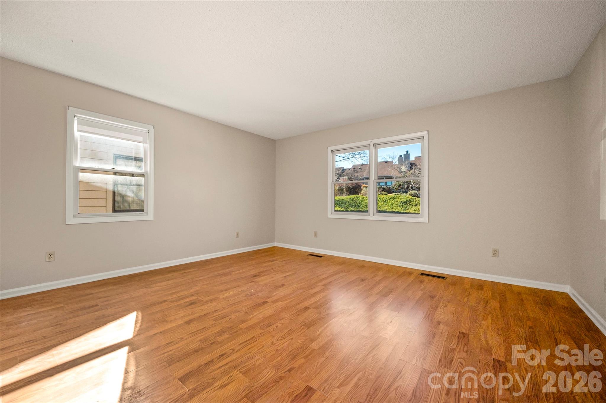 77 Chestnut Street Tryon, NC 28782 - Photo 21 of 41 a view of an empty room with wooden floor and a window