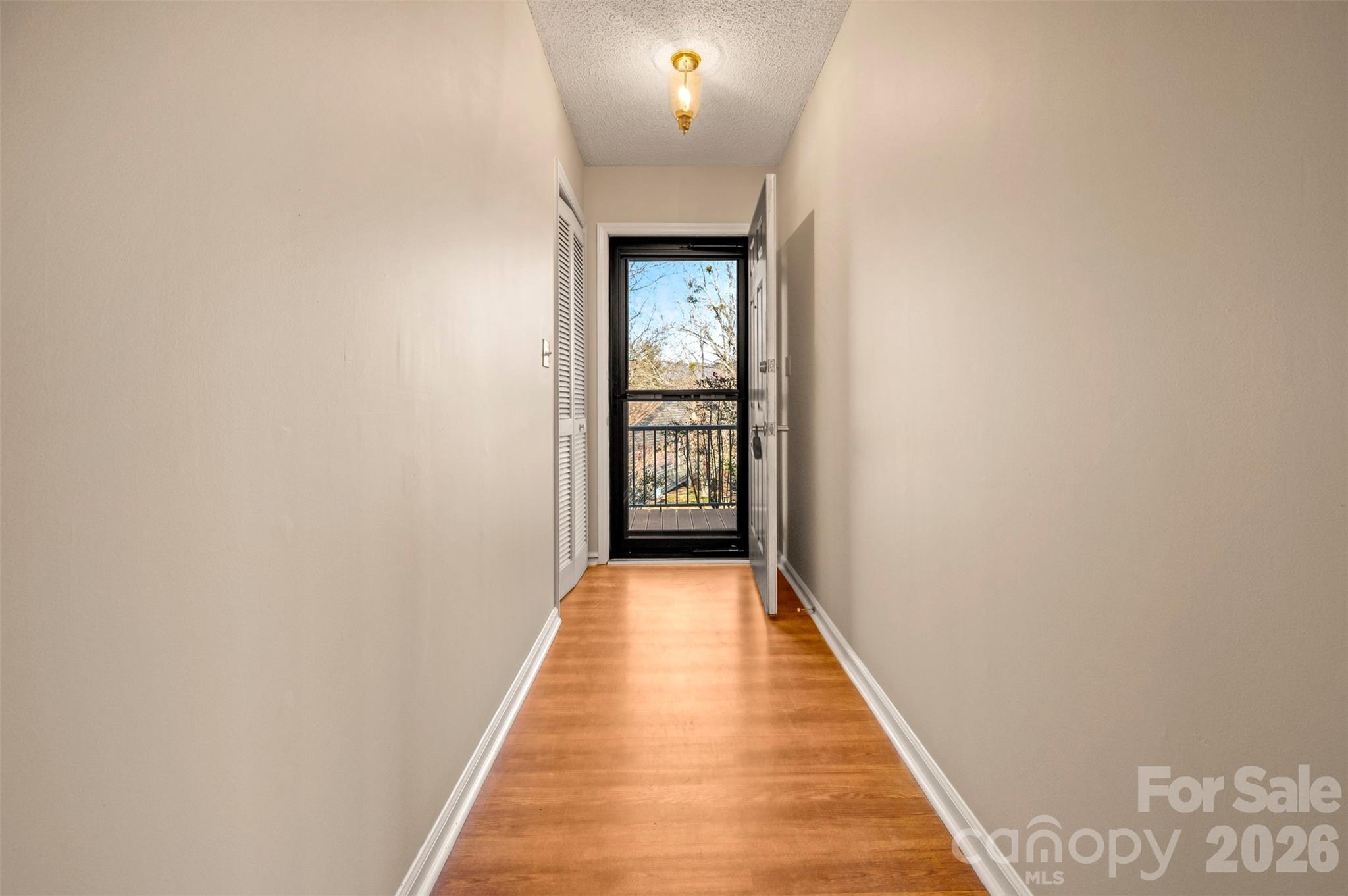 77 Chestnut Street Tryon, NC 28782 - Photo 6 of 41 a view of a hallway with wooden floor and a bathroom