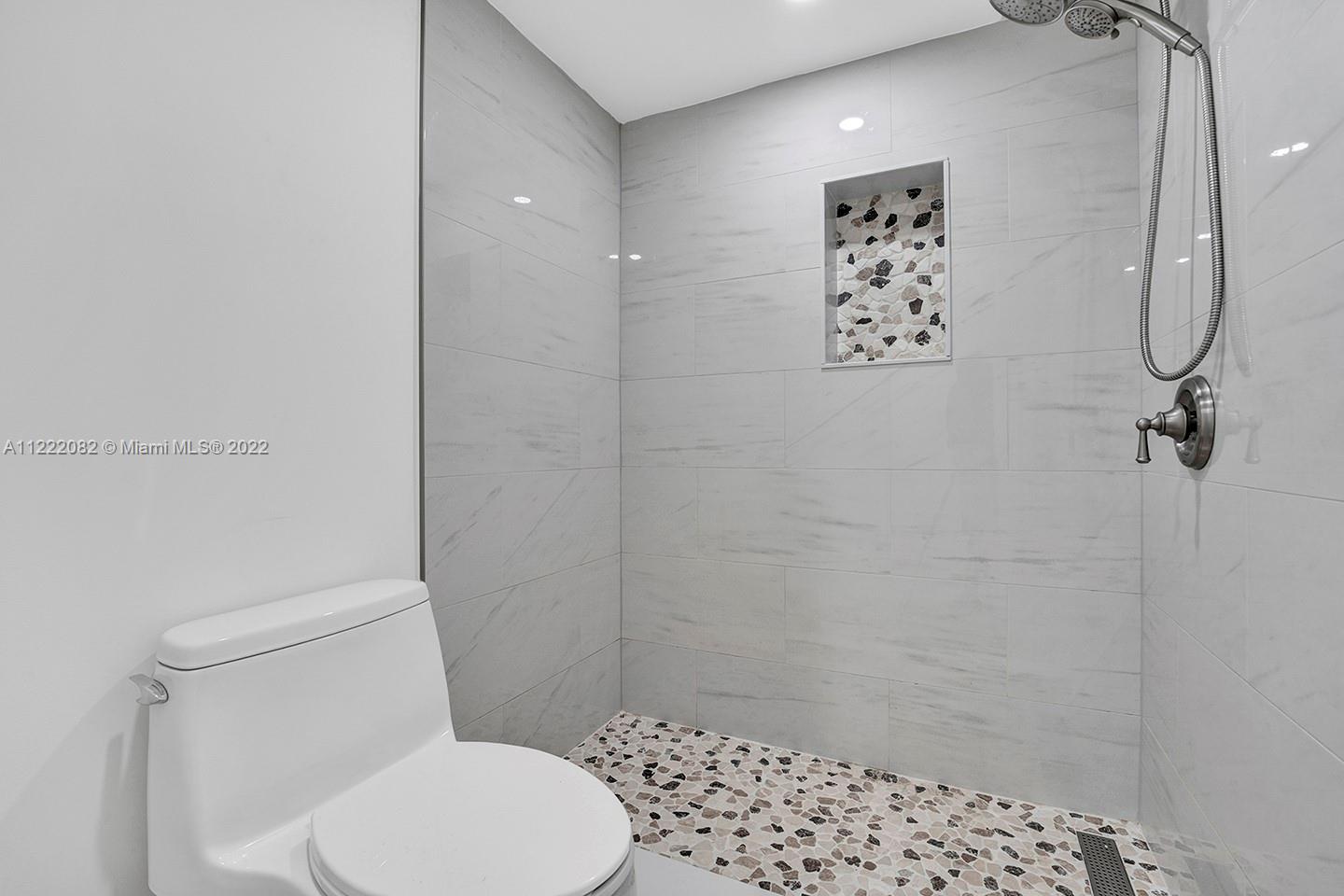 6904 North Kendall Drive, Unit F102 Pinecrest, FL 33156 - Photo 12 of 19 a white toilet sitting next to a shower