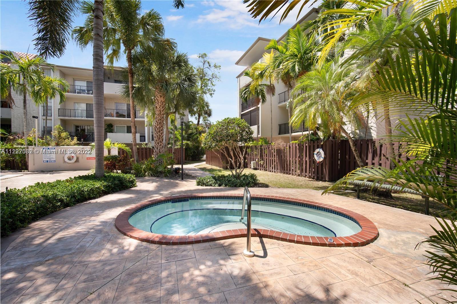 6904 North Kendall Drive, Unit F102 Pinecrest, FL 33156 - Photo 16 of 19 a view of a swimming pool with a yard