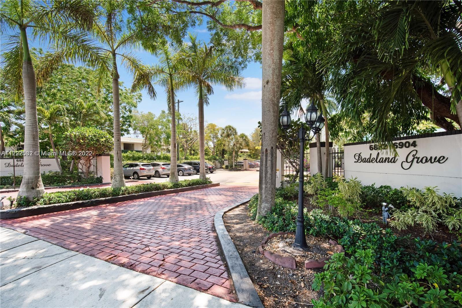 6904 North Kendall Drive, Unit F102 Pinecrest, FL 33156 - Photo 19 of 19 a view of a street with potted plants and large trees