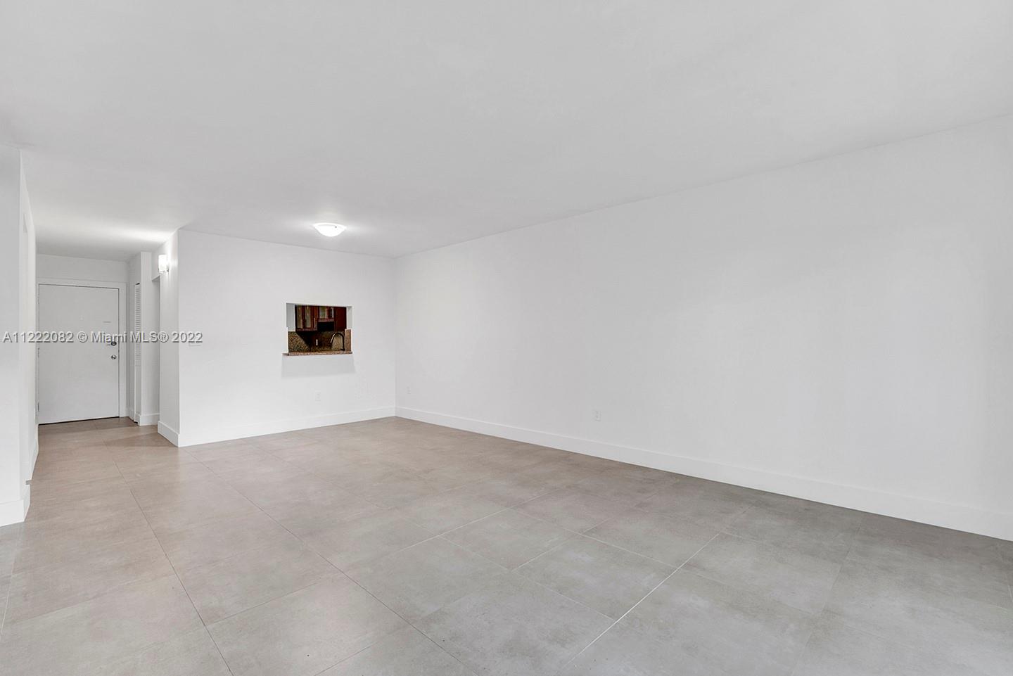 6904 North Kendall Drive, Unit F102 Pinecrest, FL 33156 - Photo 3 of 19 an empty room with an empty space and a sink