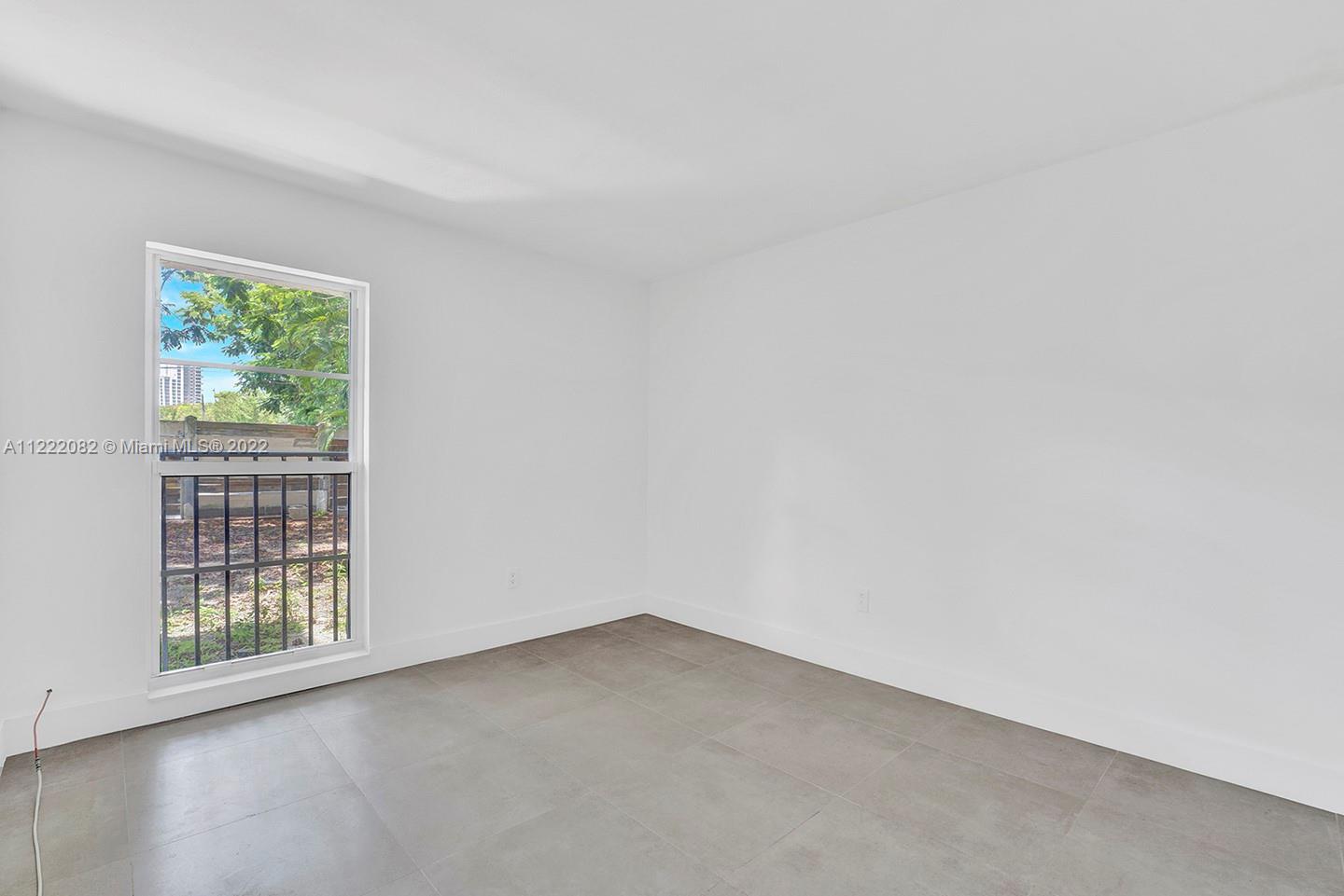 6904 North Kendall Drive, Unit F102 Pinecrest, FL 33156 - Photo 9 of 19 an empty room with windows