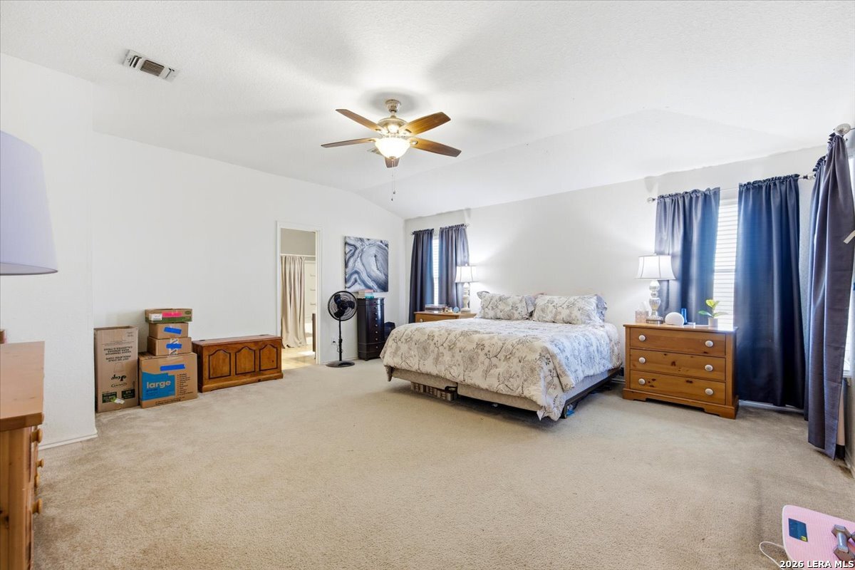 7311 Autumn Ledge Converse, TX 78109 - Photo 13 of 25 a bedroom with a bed and a chandelier