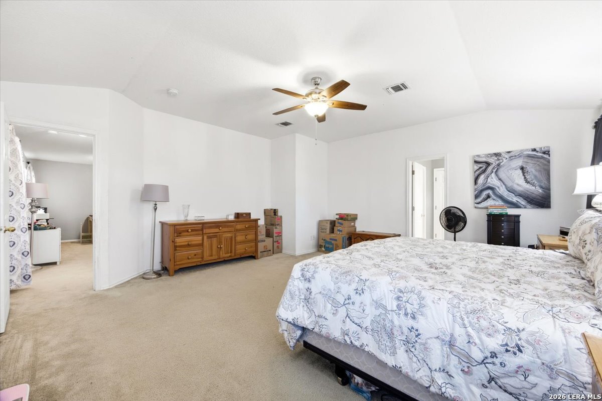 7311 Autumn Ledge Converse, TX 78109 - Photo 14 of 25 a spacious bedroom with a bed and a chandelier