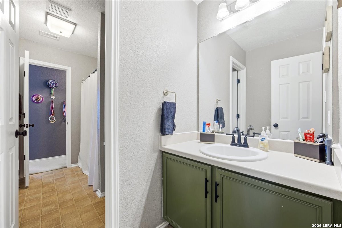 7311 Autumn Ledge Converse, TX 78109 - Photo 20 of 25 a bathroom with a sink and a mirror