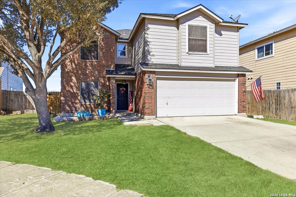 7311 Autumn Ledge Converse, TX 78109 - Photo 2 of 25 a front view of a house with a yard and garage