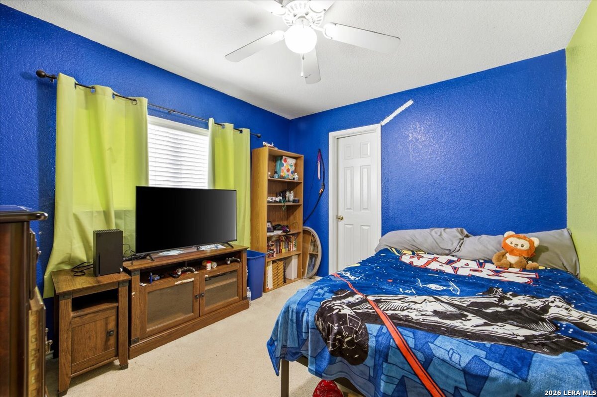 7311 Autumn Ledge Converse, TX 78109 - Photo 21 of 25 a bedroom with a bed and a flat screen tv