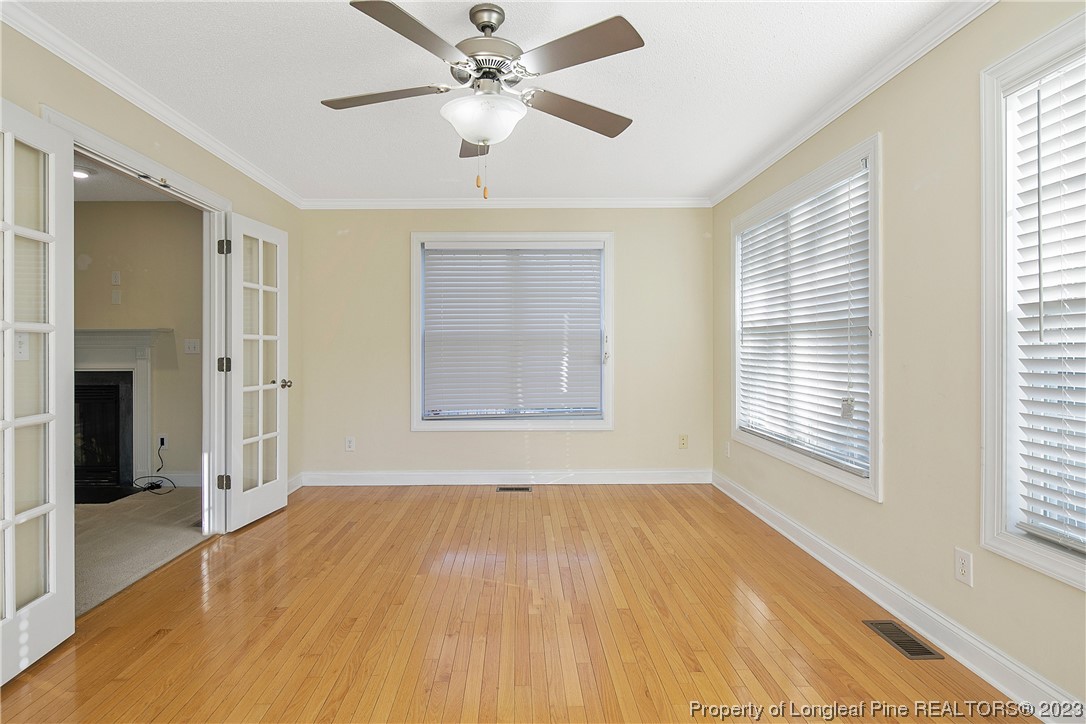 136 Linden Road Cameron, NC 28326 - Photo 14 of 48 a view of an empty room with a window and wooden floor