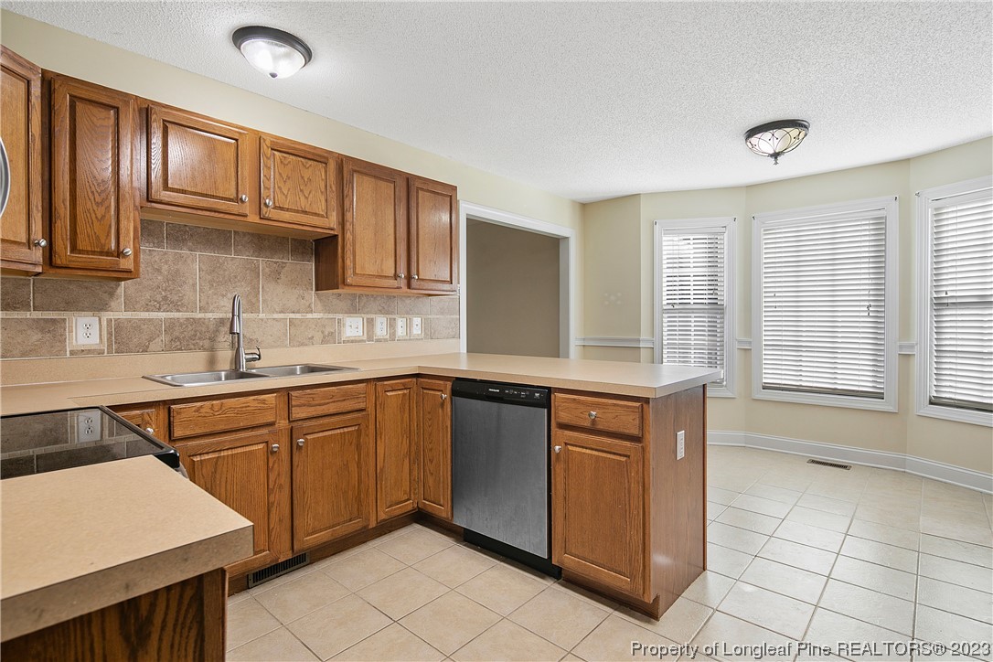 136 Linden Road Cameron, NC 28326 - Photo 19 of 48 a kitchen with stainless steel appliances granite countertop a sink and cabinets