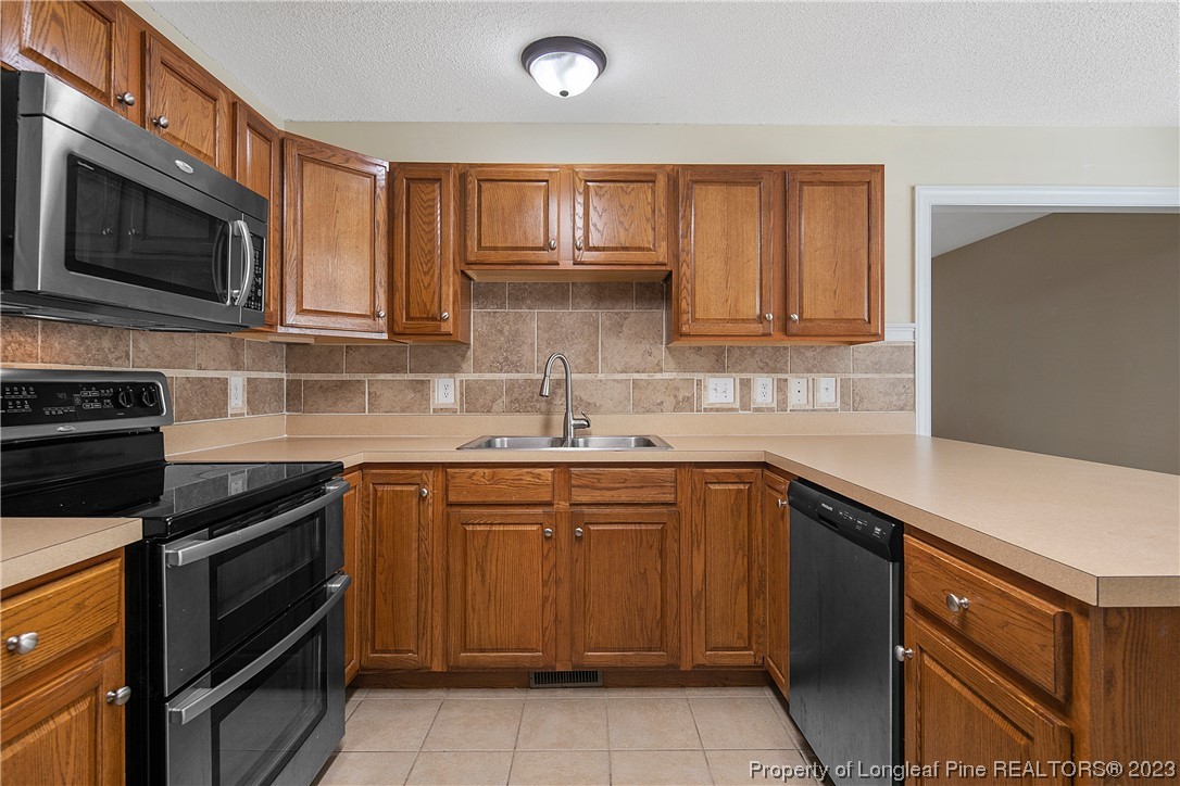 136 Linden Road Cameron, NC 28326 - Photo 20 of 48 a kitchen with a sink stove and microwave