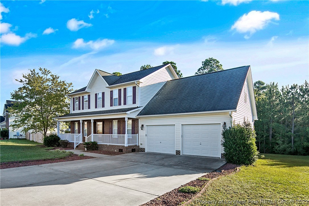 136 Linden Road Cameron, NC 28326 - Photo 2 of 48 a view of a white building among the street with palm trees