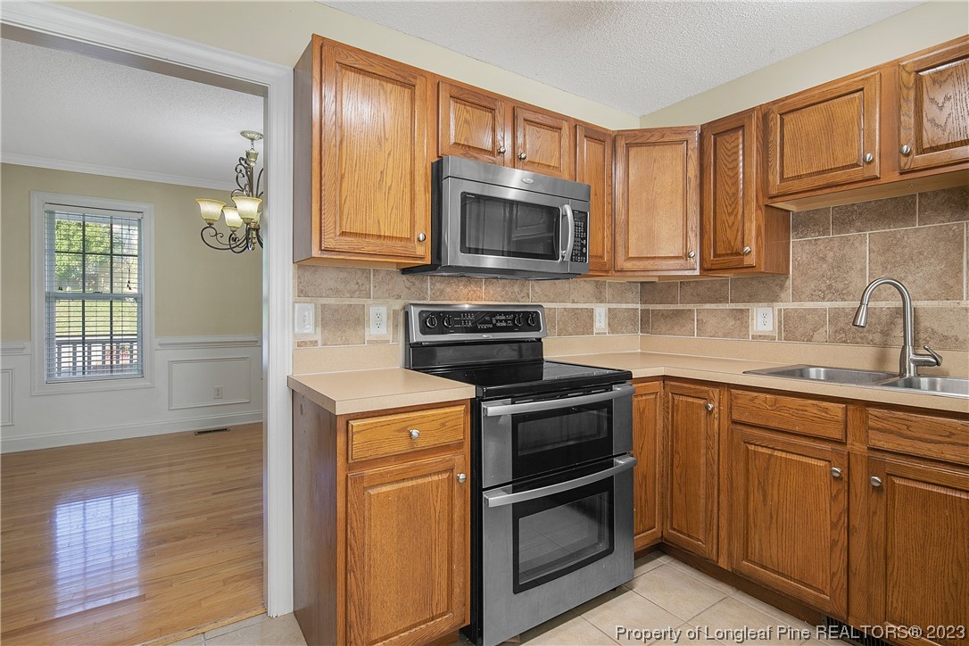136 Linden Road Cameron, NC 28326 - Photo 21 of 48 a kitchen with a sink stove and microwave