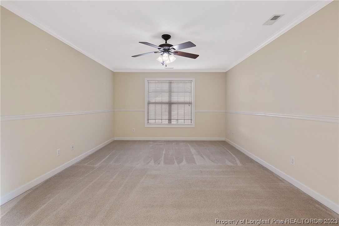 136 Linden Road Cameron, NC 28326 - Photo 28 of 48 an empty room with windows and ceiling fan