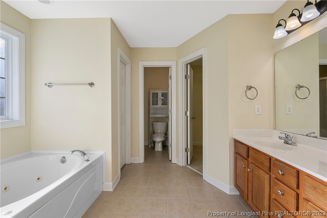 136 Linden Road Cameron, NC 28326 - Photo 29 of 48 a spacious bathroom with a tub sink and mirror