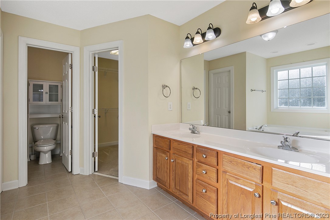 136 Linden Road Cameron, NC 28326 - Photo 30 of 48 a spacious bathroom with double vanity sinks a mirror and a shower
