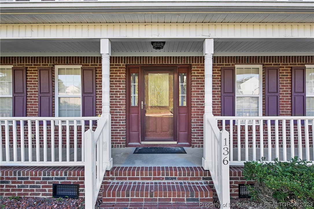 136 Linden Road Cameron, NC 28326 - Photo 3 of 48 an entrance view of a house with a balcony