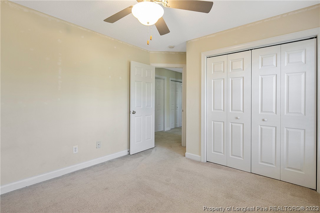 136 Linden Road Cameron, NC 28326 - Photo 35 of 48 an empty room with a ceiling fan and a window