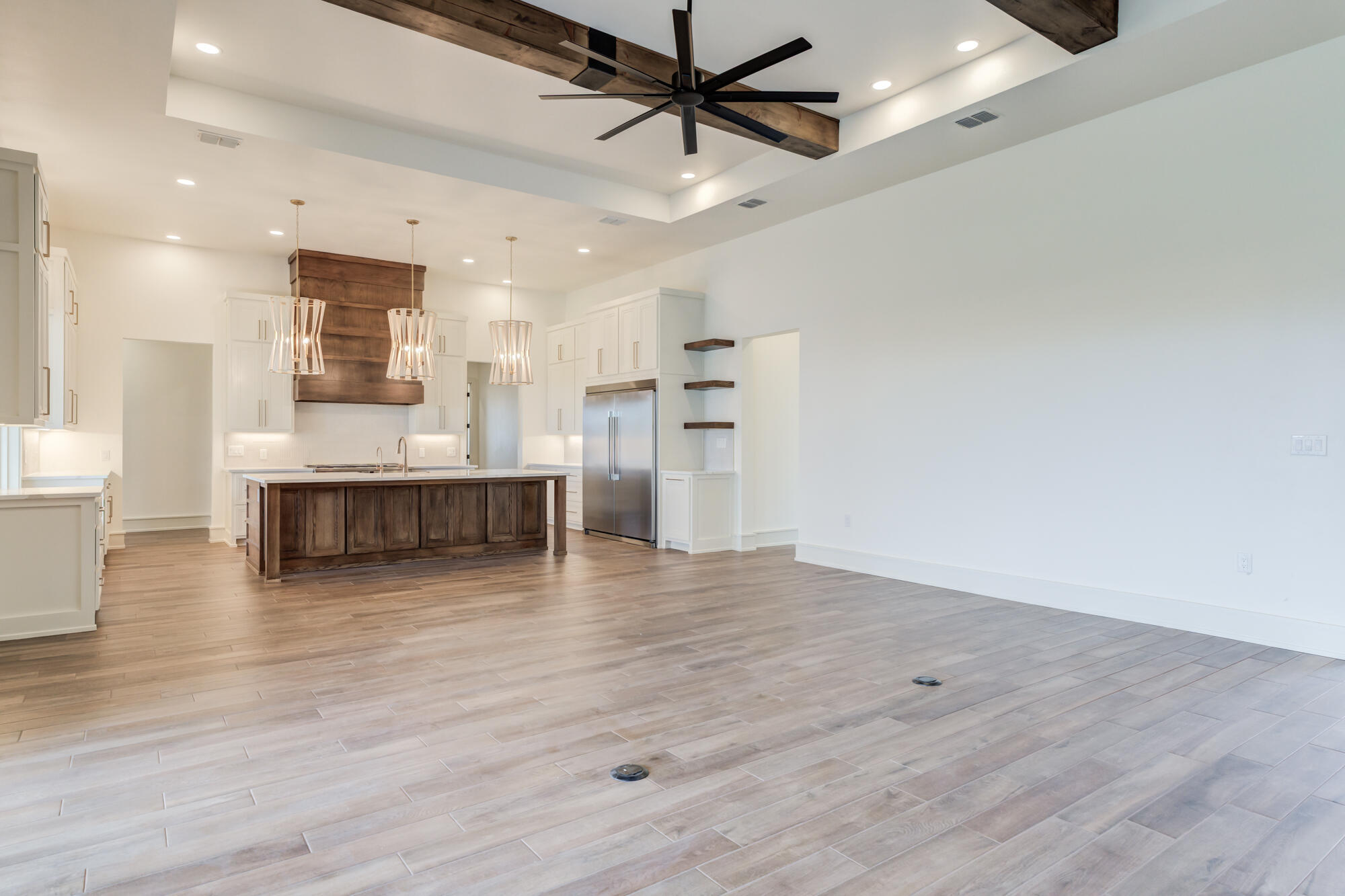 7710 46th Street Lubbock, TX 79407 - Photo 13 of 79 a view of a kitchen with a refrigerator and a ceiling fan