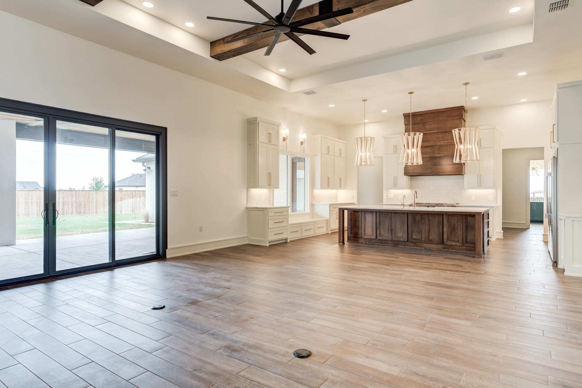 7710 46th Street Lubbock, TX 79407 - Photo 15 of 79 a view of an empty room with wooden floor and a window