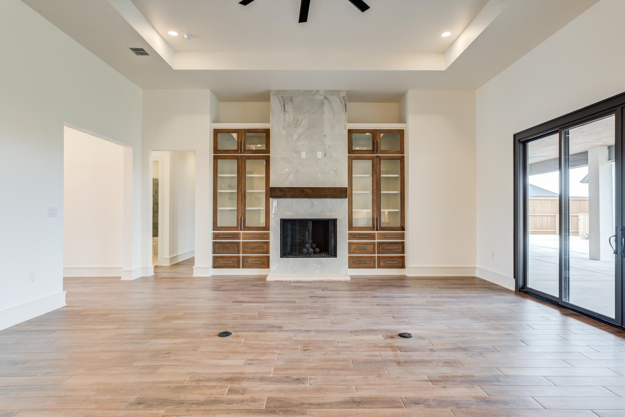 7710 46th Street Lubbock, TX 79407 - Photo 16 of 79 a view of an empty room with wooden floor and a window