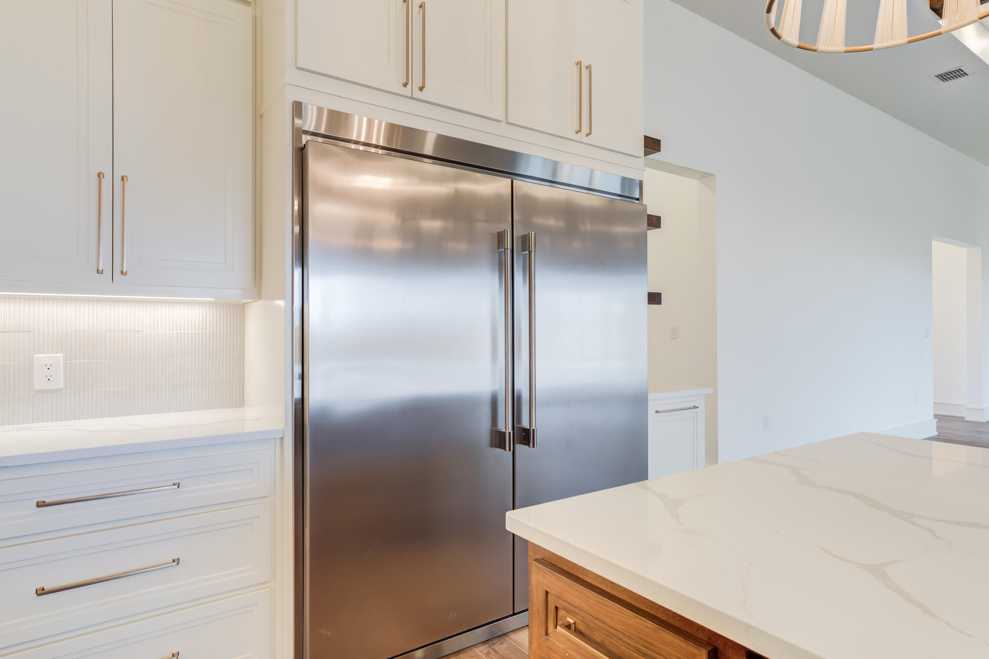 7710 46th Street Lubbock, TX 79407 - Photo 26 of 79 a kitchen with a refrigerator and cabinets