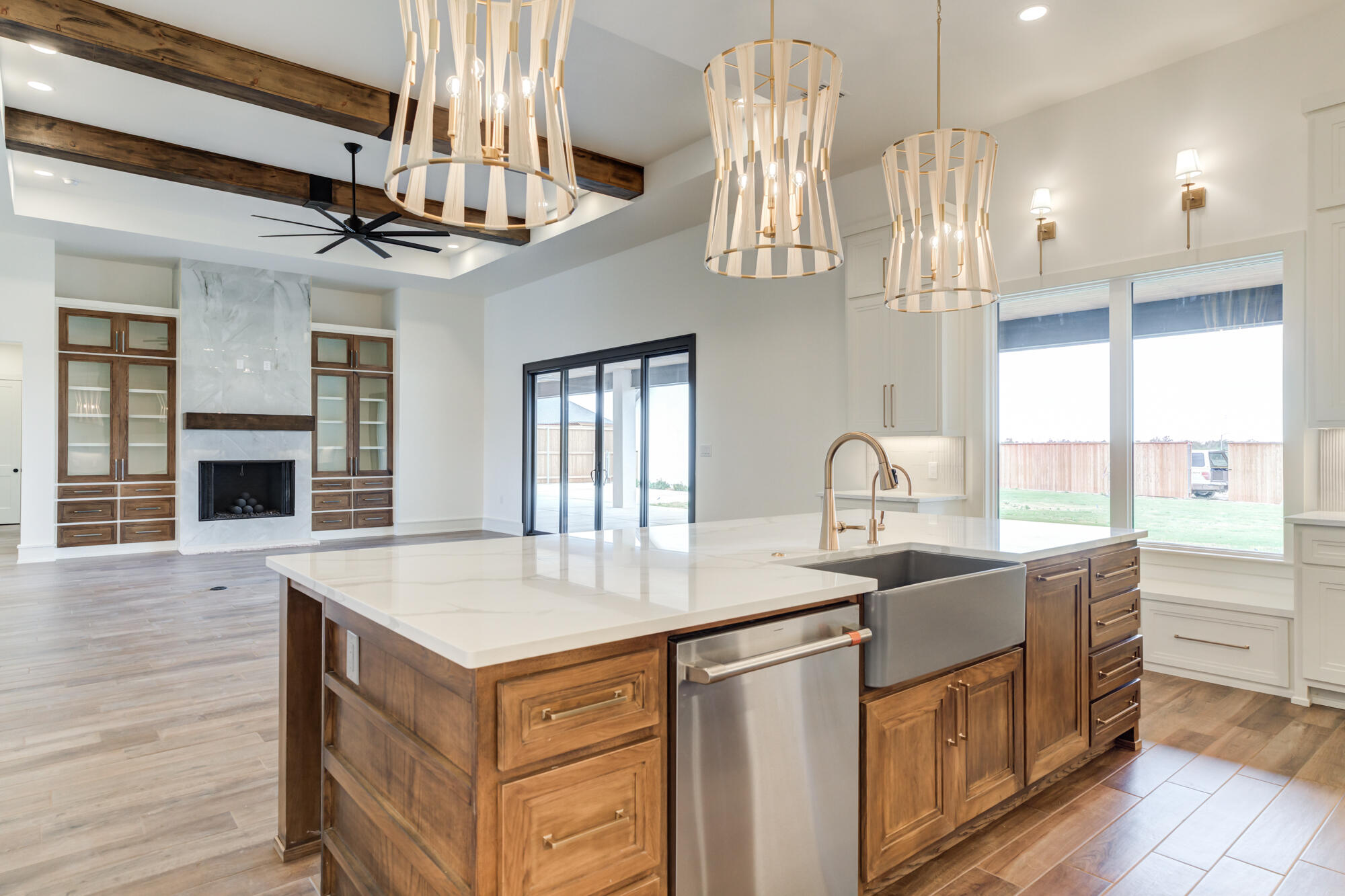 7710 46th Street Lubbock, TX 79407 - Photo 28 of 79 a open kitchen with stainless steel appliances granite countertop a sink a oven and a fireplace with wooden floor