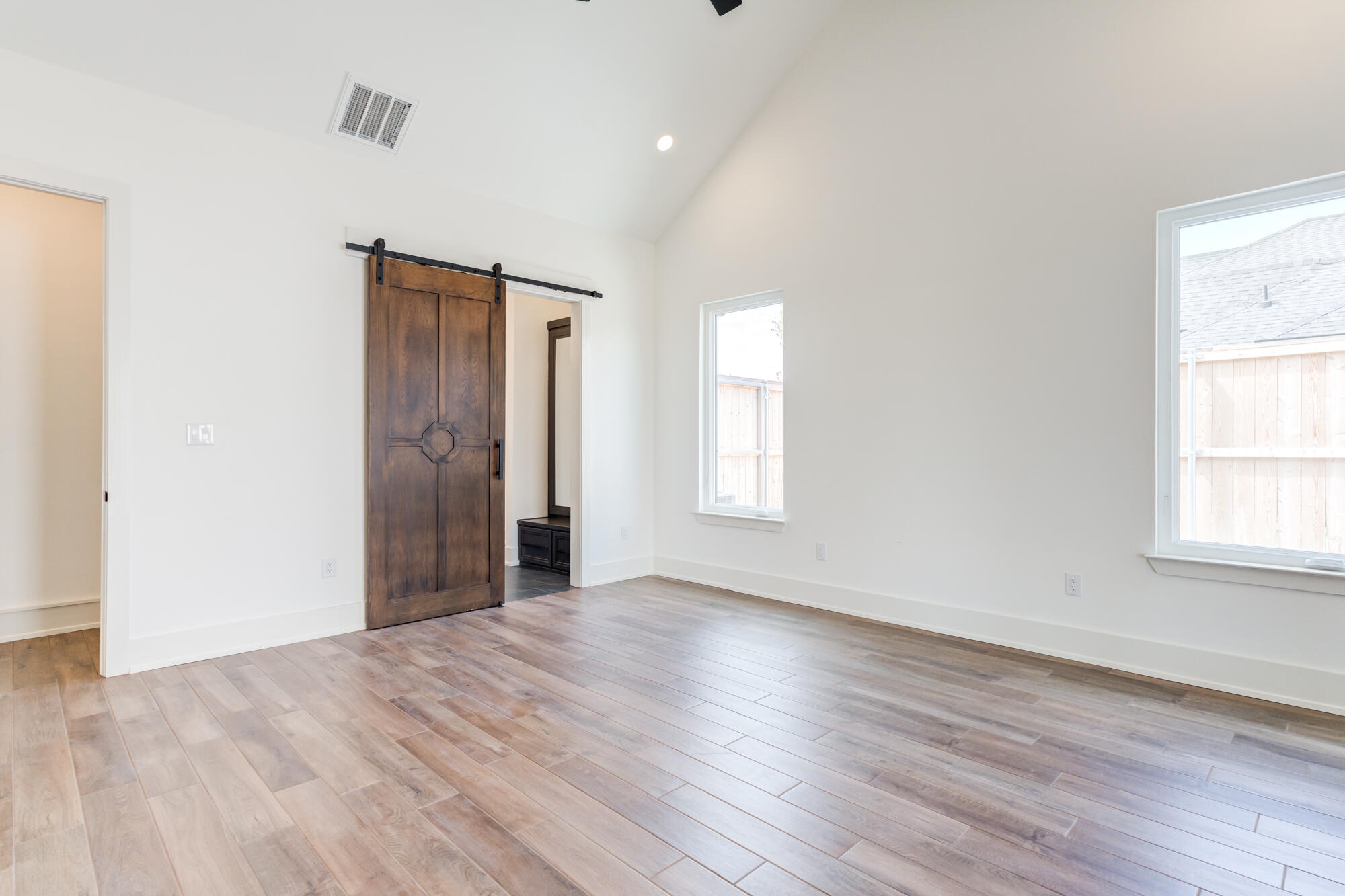 7710 46th Street Lubbock, TX 79407 - Photo 35 of 79 an empty room with wooden floor and windows