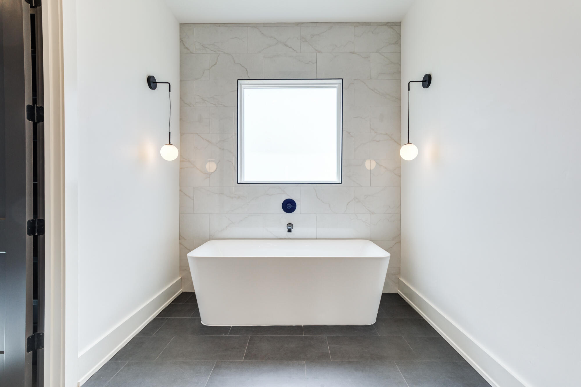 7710 46th Street Lubbock, TX 79407 - Photo 41 of 79 a white bath tub sitting in a bathroom